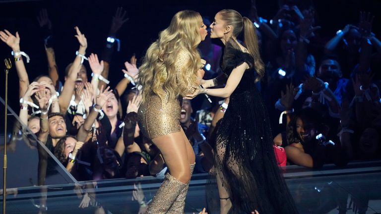 Not quite the Madonna and Britney Spears kiss of 2003 - Ariana Grande and Mariah Carey share a peck. Pic: AP