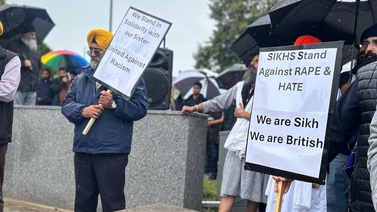 People held signs with messages including 'Unite Against Racism' 