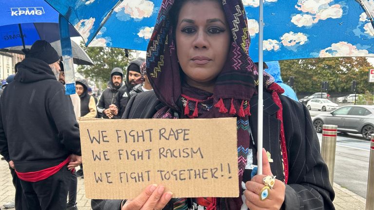 A woman holds a sign to show support 