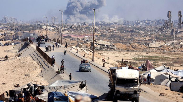 Smoke rises as displaced Palestinians fled northern Gaza on Tuesday. Pic: Reuters