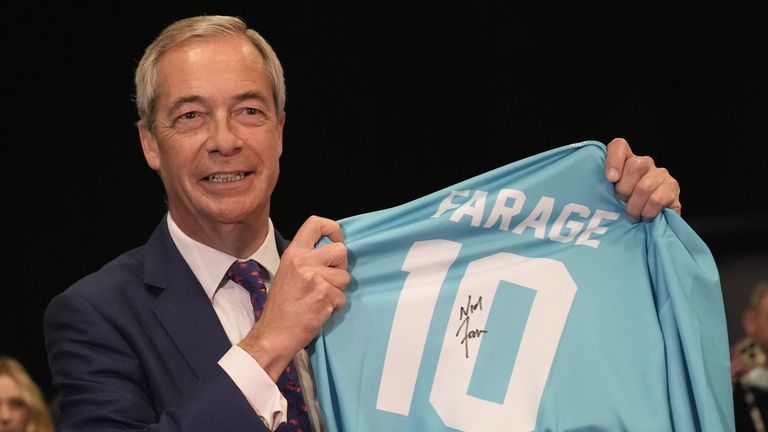 Reform UK leader Nigel Farage with a football shirt during the party's annual conference in Birmingham. Pic PA