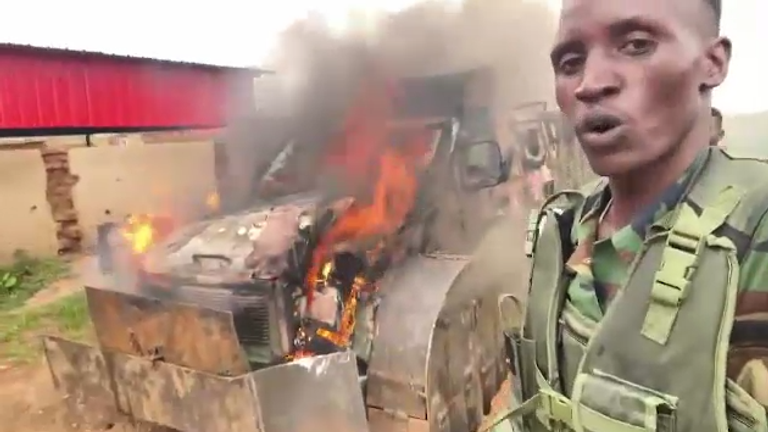 Sudanese state forces in front of burning armed vehicles that appear to have come from the UAE