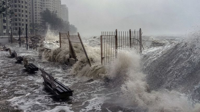 Waves crash against the waterfront in Hong Kong. Pic: AP