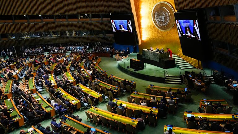 Palestinian President Mahmoud Abbas appears on a screen