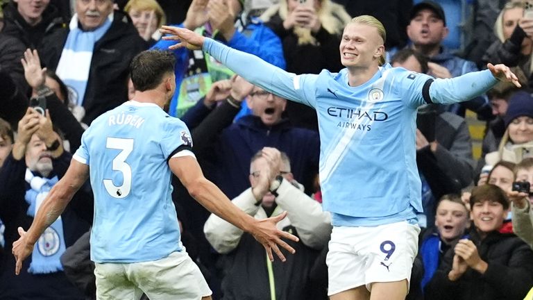 Erling Haaland celebrates his second goal with Ruben Dias