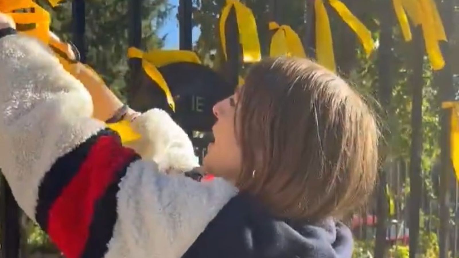 Woman filmed cutting commemorative yellow ribbons for Israeli hostages