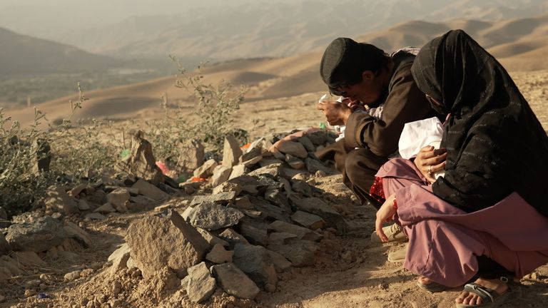 Nasrullah and Jamilah at the grave of their daughter, Shukriya