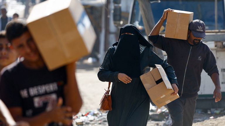 Palestinians carry aid supplies that entered Gaza. Pic: Reuters