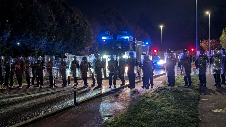 Police officers block protesters outside the hotel. Pic: PA