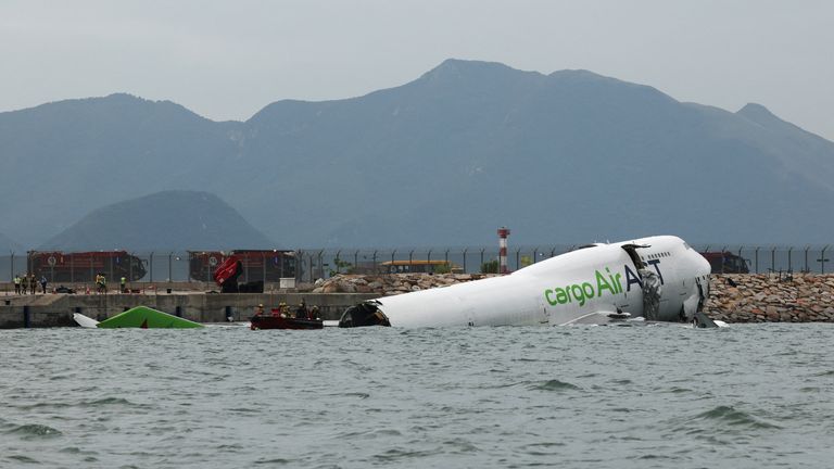 Cargo plane slides off runway in Hong Kong - reports say two dead