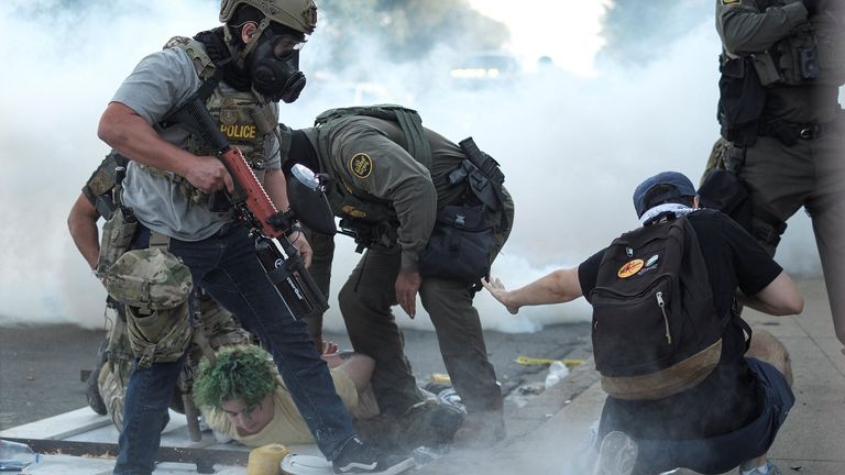 A demonstrator is arrested in Chicago on Sunday during a protest against an immigration crackdown. Pic: Reuters