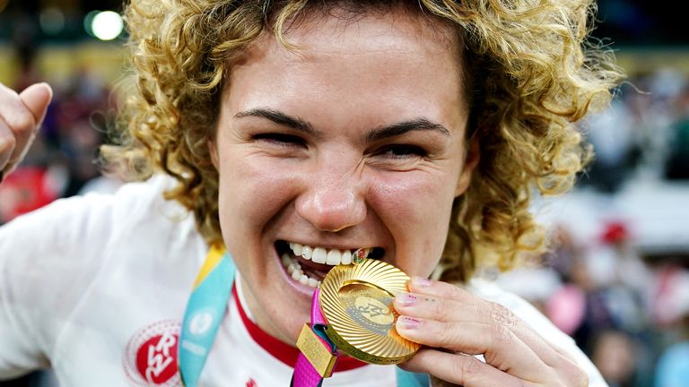 England's Ellie Kildunne bites her winners medal as she celebrates after the Women's Rugby World Cup final at the Allianz Stadium, London. P