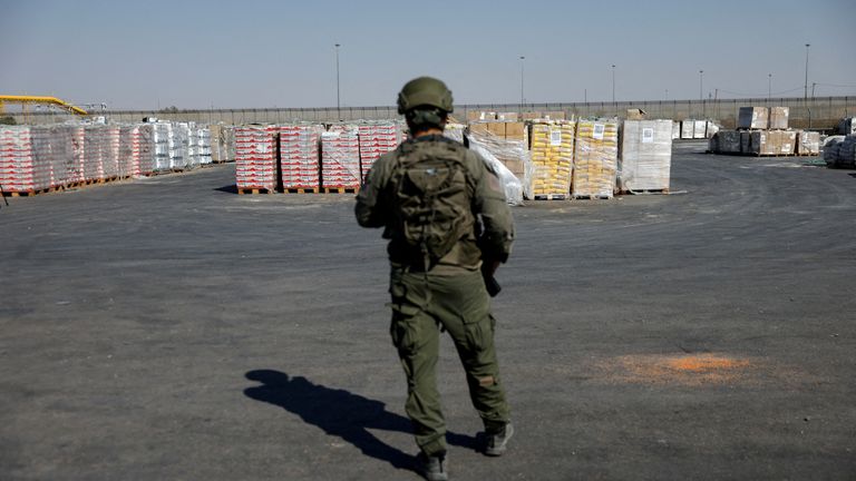 An Israeli soldier stands next to the parcels of humanitarian aid awaiting to be transferred into Gaza in July. File pic: Reuters