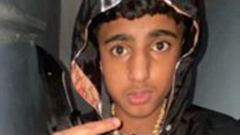 Khan pictured holding the weapon used to kill Harvey Willgoose. Pic: South Yorkshire Police