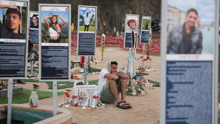Portraits of the kidnapped and dead at the site of the Nova festival. Pic: Reuters