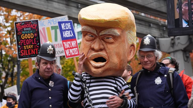 A Donald Trump is presented as a prisoner in chains in Seattle. Pic: AP