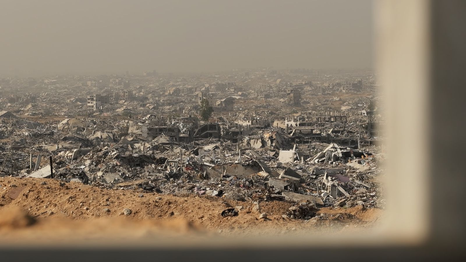 'Patchwork of dust and misery': At the Yellow Line dividing Gaza - where all that remains are skeletons of buildings