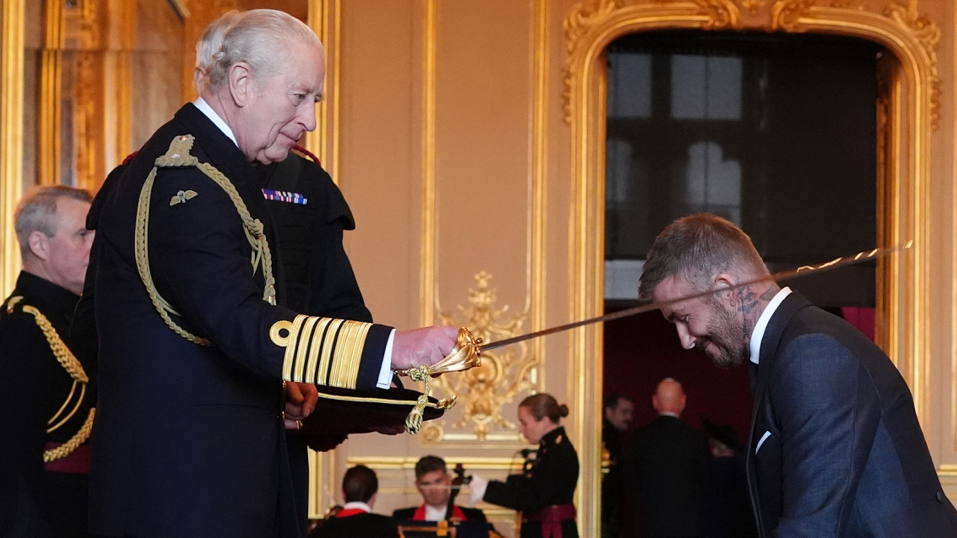 Arise, Sir David! Beckham receives knighthood from the King
