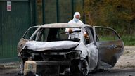 A French gendarme inspects the burnt car used by a driver who rammed into pedestrians and cyclists.
Pic: Reuters