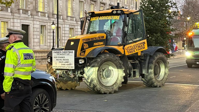 A tractor from the Littledown Christmas Tree Farm arrives for a protest by farmers in Whitehall. Pic: PA