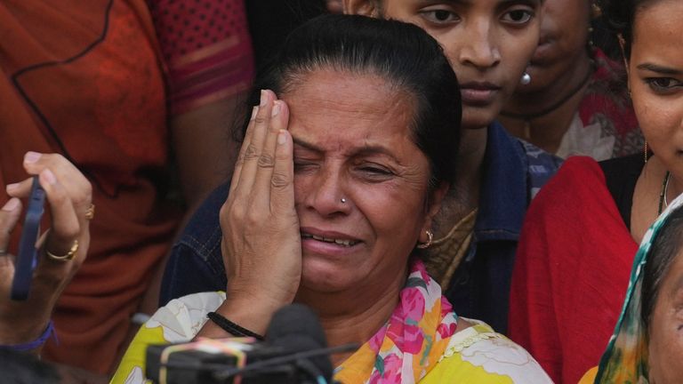 A Dharmendra fan mourns outside the crematorium in Mumbai. Pic: AP