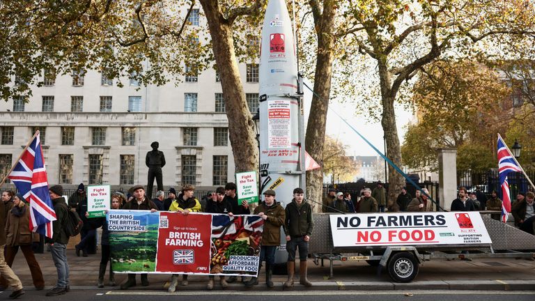 Protesters hold a banner next to a fuel tanker shaped like a missile at Whitehall. Pic: Reuters