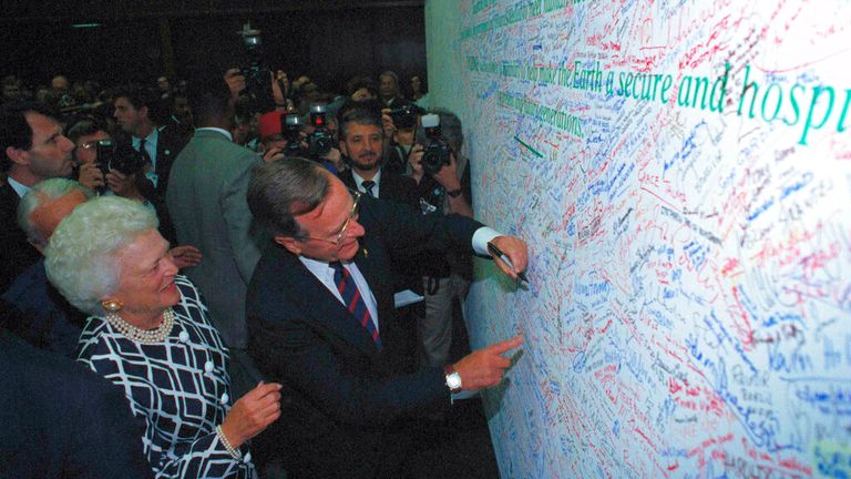 George Bush is watched by first lady Barbara Bush as he signs the Earth Pledge at the Earth Summit in Rio de Janeiro