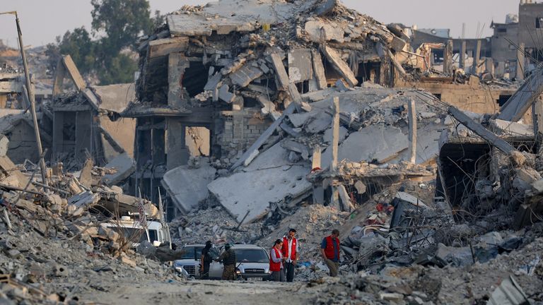 Hamas militants and Red Cross members work at a site in Gaza City. Pic: Reuters