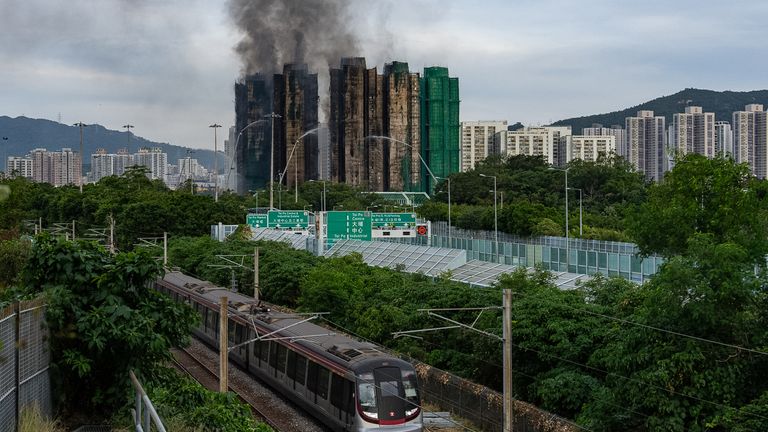 Smoke rises from the complex. Pic: AP Photo/Chan Long Hei