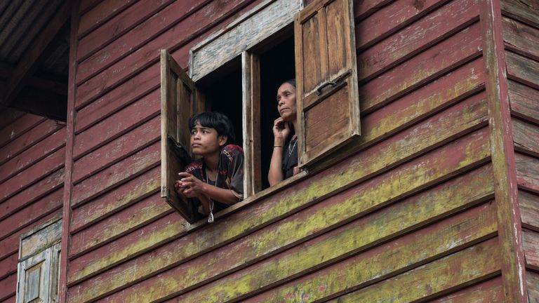 Many homes in Dak Cheung are still simple wooden structures