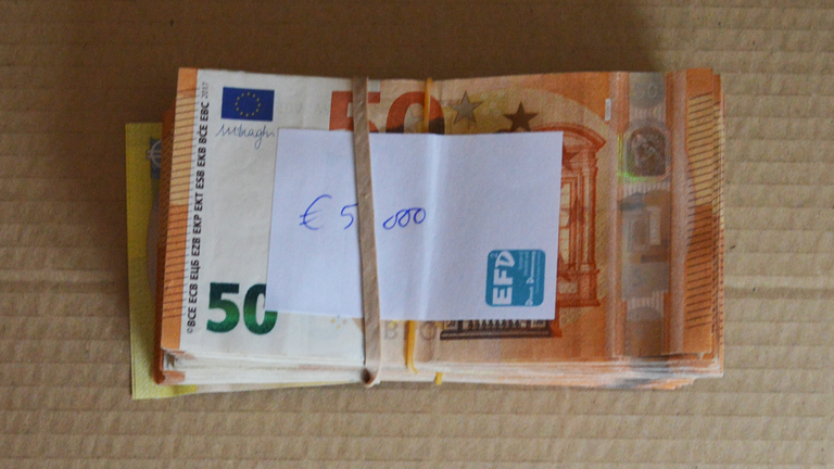 Bundles of cash were recovered from Gill's home. Pic: Met Police