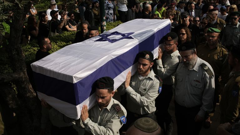 Israel receives hostage's stays - as Turkey points arrest warrants for 36 officers concerned within the conflict 2 IDF troops carry the coffin of hostage Omer Neutra. Pic: AP