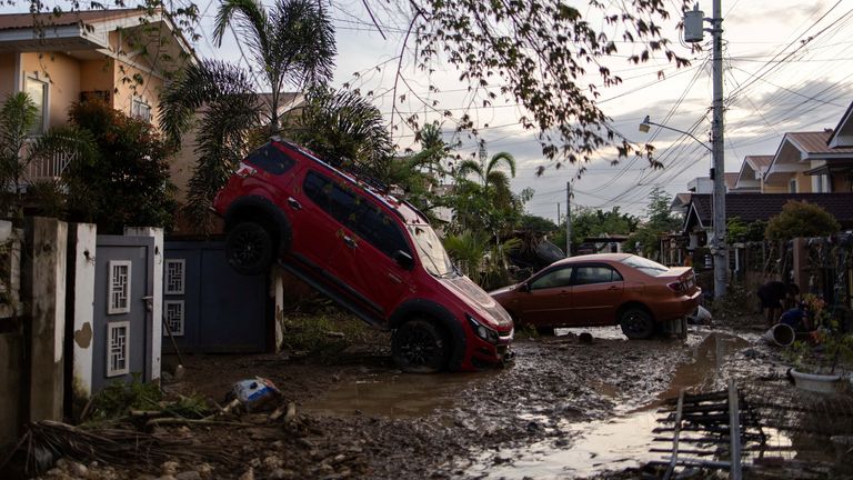 Cars swept away by floods brought by Typhoon Kalmaegi are left on a street in Cotcot, Liloan, Philippines. Pic: Reuters