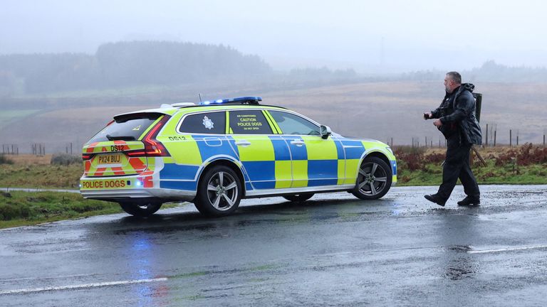 A police officer maintains a road block near the scene of a train derailment near Shap. Pic: Reuters