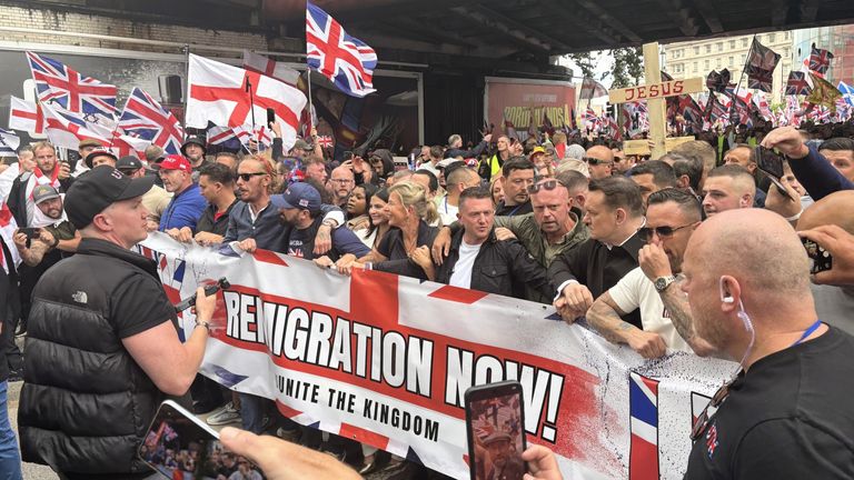 Tommy Robinson stands at the start of the Unite The Kingdom protest in central London