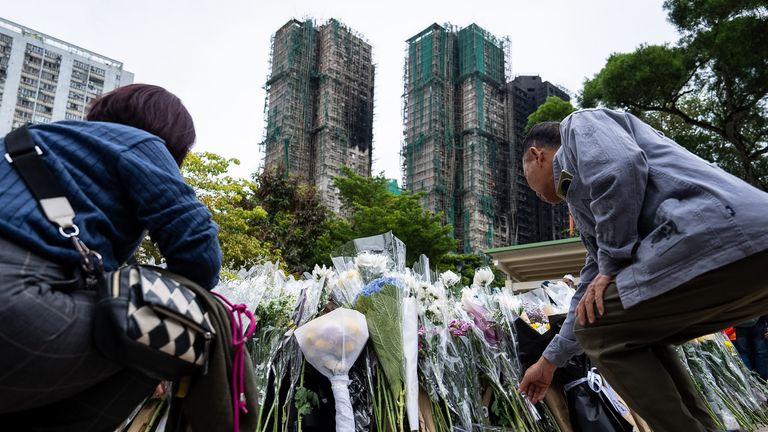 People offer flowers for the victims. Pic: AP