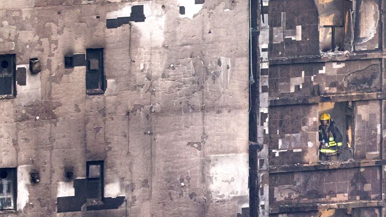 Firefighters searching between floors at one of the high-rise blocks. Pic: Reuters
