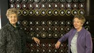 War veterans Ruth Bourne, left, and Jean Valentine, stand in front of a replica of the Turing Bombe machine. Pic: AP