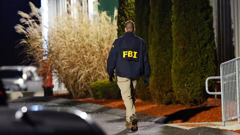 An investigator works the scene at the storage facility where Neves Valente was found dead. Pic: Reuters
