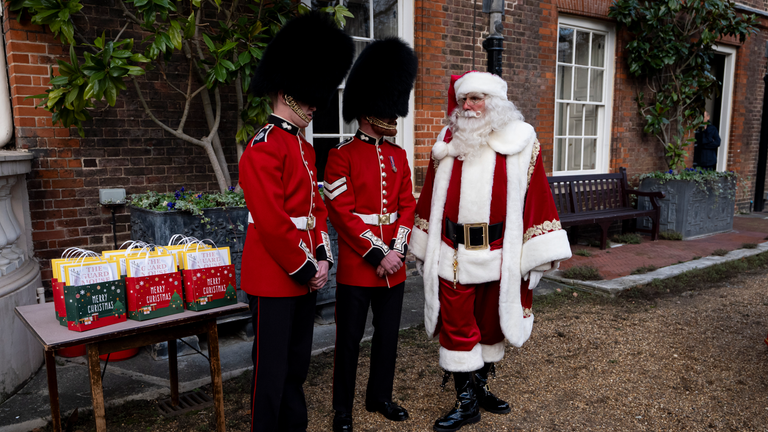 Soldiers chat with Father Christmas.