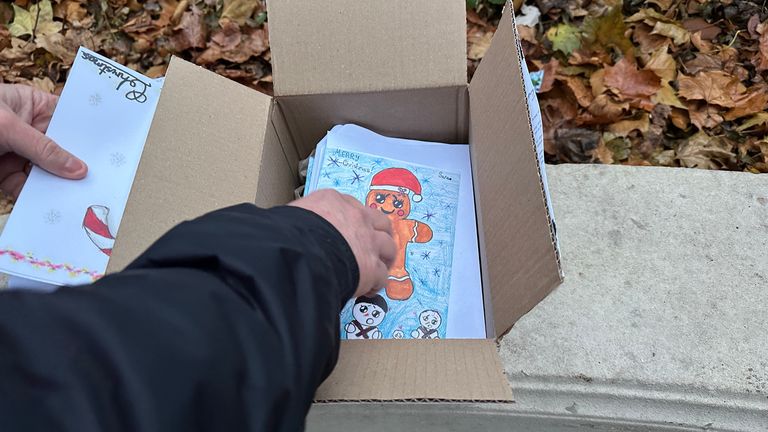 The container  of Christmas cards being inspected for signs of danger.