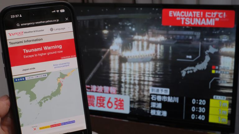 A TV monitor and a smartphone show the earthquake that struck off the coast of Aomori Prefecture, Japan, on December 8, 2025. Around 11:15 pm on the same day, an earthquake with its epicenter off the east coast of Aomori Prefecture occurred. According to the Japan Meteorological Agency, the epicenter was estimated to be about 50 km deep, and the earthquake&#39;s magnitude was 7.6 on the Richter scale. The quake registered a seismic intensity of 6+ in Hachinohe City, Aomori Prefecture, and 6- in Oirase Town and Hashikami Town, Aomori Prefecture. Tsunami warnings have been issued for the Pacific coast of Aomori Prefecture, the Pacific coast of Hokkaido, and Iwate Prefecture. ( The Yomiuri Shimbun via AP Images )