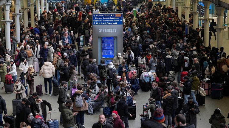 Passengers wait with luggage, after a Eurostar spokesperson said they were suspending its cross-Channel train services to and from London un