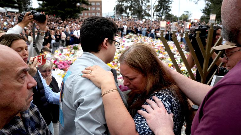 Matilda'nın annesi, Bondi Plajı'ndaki anma töreninde konuştuktan sonra oğluna sarılıyor. Resim Reuters