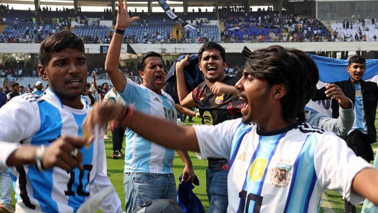 People flooded onto the pitch after Messi departed. Pic: Reuters