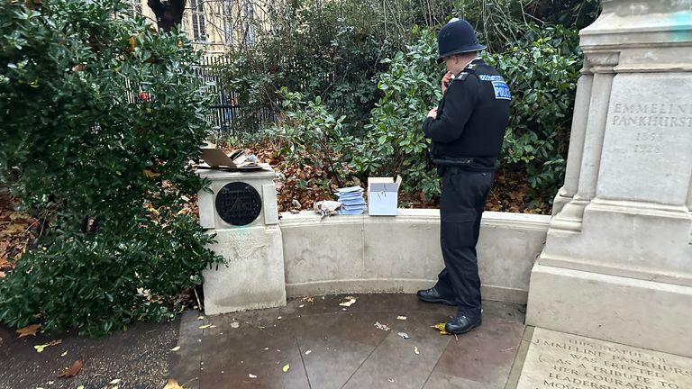 A constabulary  serviceman  inspecting the container  of cards that triggered a lockdown of Westminster.