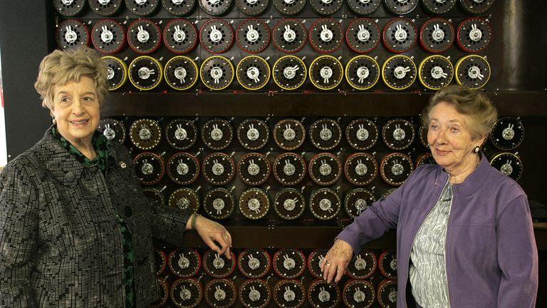 Ruth Bourne, left, and fellow veteran, Jean Valentine, stand in front of a replica Turing Bombe machine. Pic: AP