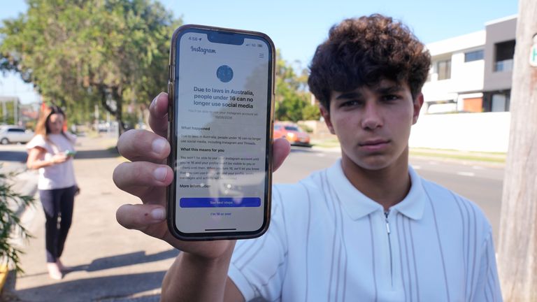 Sydney teenager, Noah Jones, 15, shows the warning on his phone that says he cannot access Instagram. Pic: AP