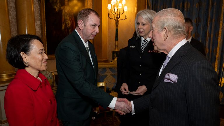 The monarch greets Stephen Crean and his wife Monludee Crean during the reception. Pic: PA