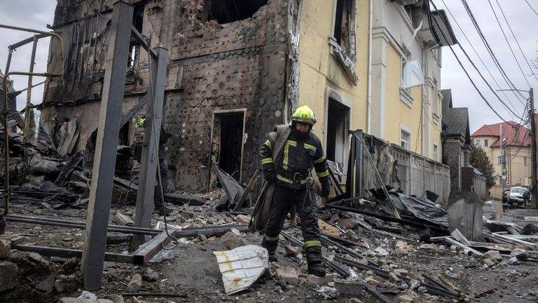 A firefighter walks at the site of a Russian attack in Kyiv. Pic: Reuters